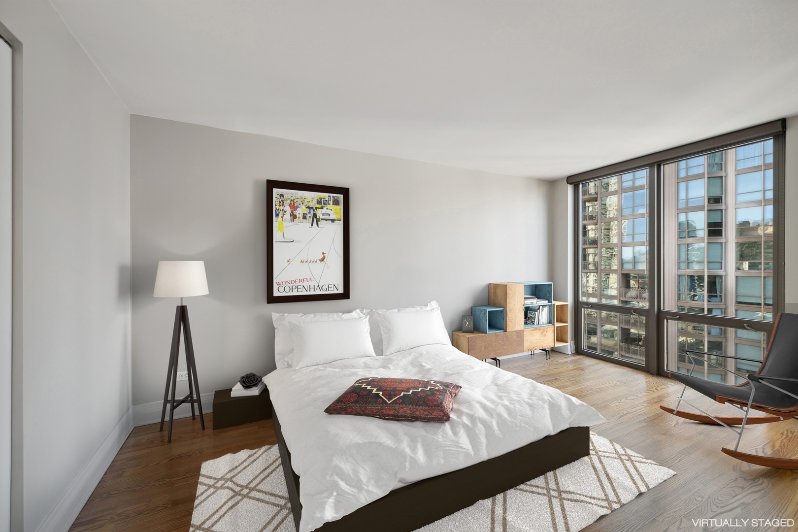 2 East Erie Street, Unit 1501 Chicago, IL 60611 - Photo 15 of 18 a bedroom with a bed and wooden floor