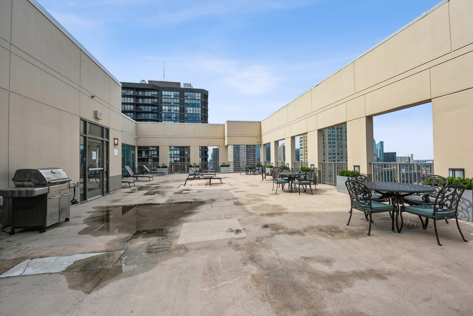 2 East Erie Street, Unit 1501 Chicago, IL 60611 - Photo 18 of 18 a view of a patio with a table and chairs and potted plants