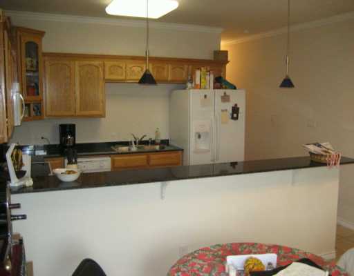 13997 Ports O Call Drive, Unit C Corpus Christi, TX 78418 - Photo 3 of 4 a kitchen with a sink a stove and a refrigerator
