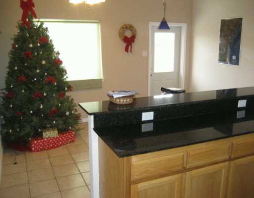 13997 Ports O Call Drive, Unit C Corpus Christi, TX 78418 - Photo 4 of 4 a kitchen with a sink and a mirror