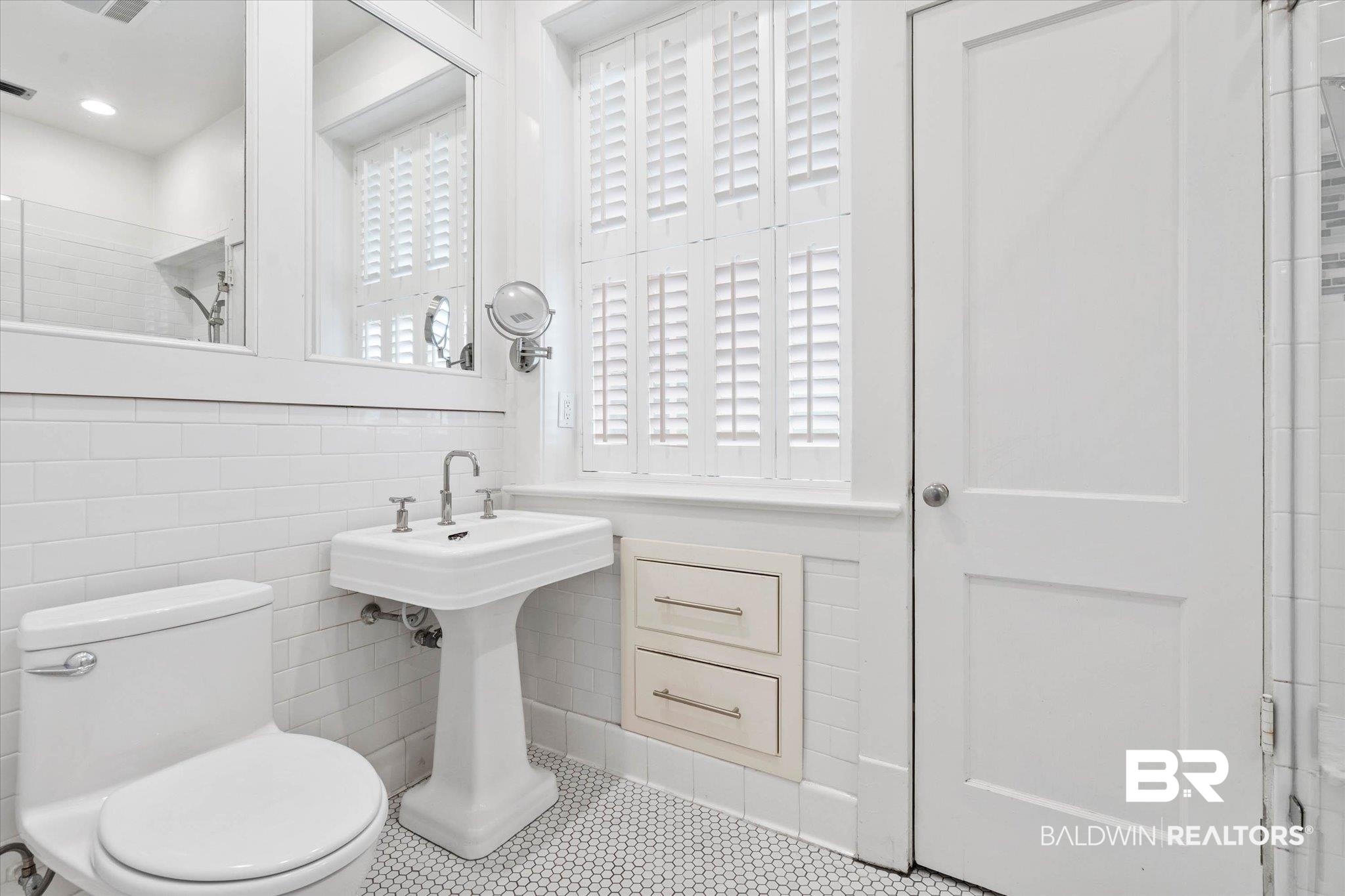 3863 Old Shell Road Mobile, AL 36608 - Photo 24 of 48 Pedestal sink with polished chrome fixtures, accented by white subway tile walls