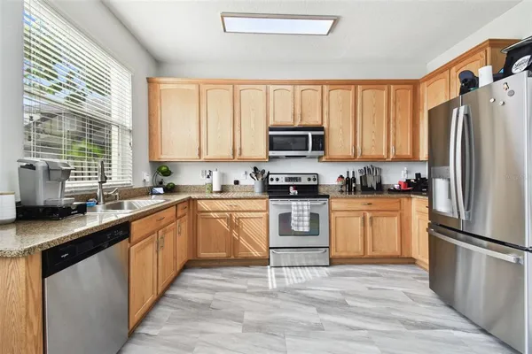 a living room with furniture a flat screen tv and a wall painting