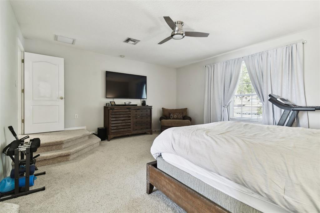 5707 Butterfield Street Riverview, FL 33578 - Photo 33 of 67 a bedroom with a bed a flat screen tv and a large window