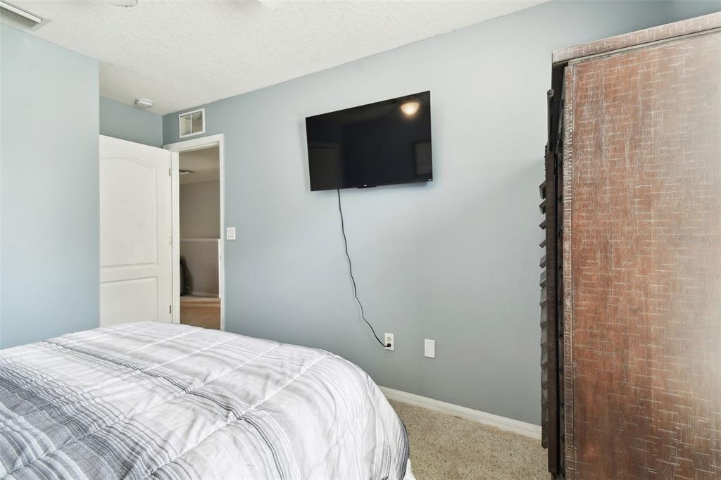 5707 Butterfield Street Riverview, FL 33578 - Photo 46 of 67 a bedroom with a bed and a flat screen tv