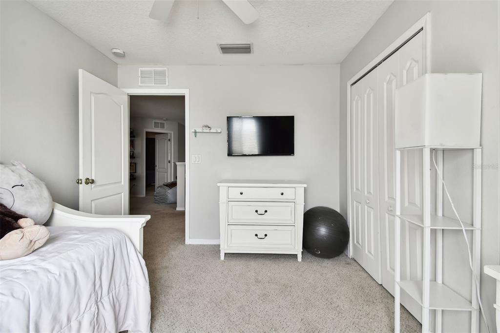 5707 Butterfield Street Riverview, FL 33578 - Photo 48 of 67 a bedroom with a bed and a television