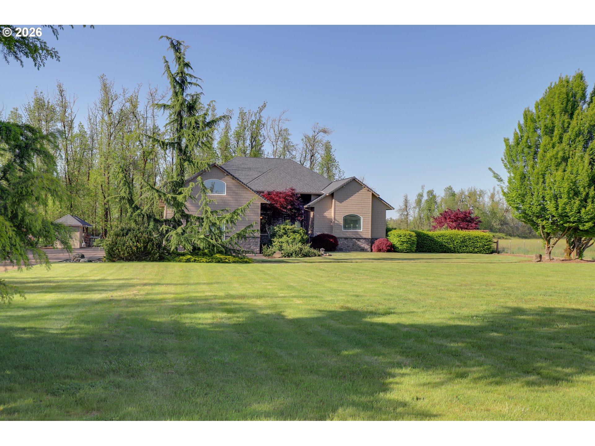 a front view of a house with a garden