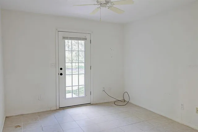 an empty room with wooden floor closet and windows