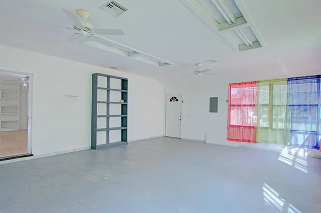 a view of a swimming pool with a table and chairs under an umbrella