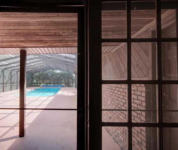 an aerial view of a house with a yard and trees