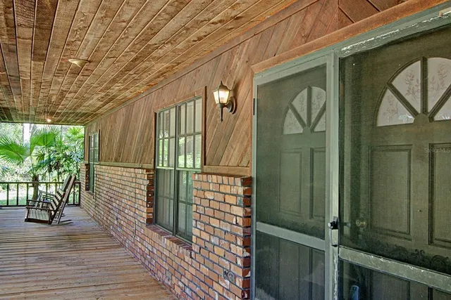 a view of a balcony with wooden floor