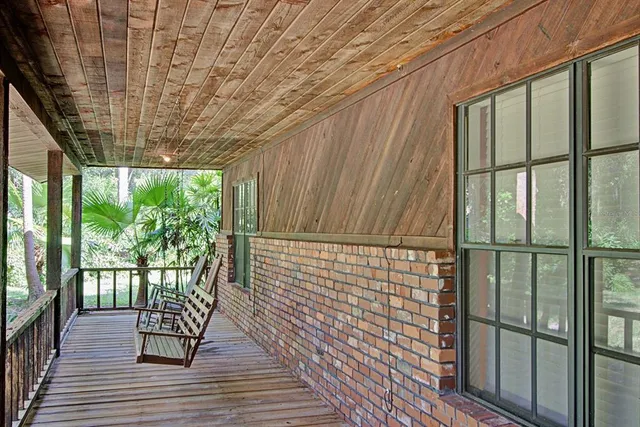 a view of a porch with wooden floor and outdoor space