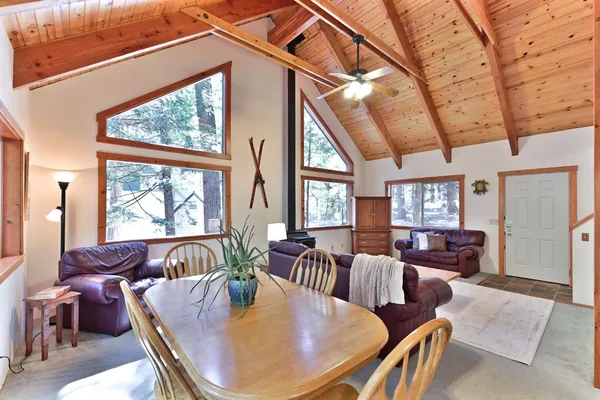 a dining room with furniture a chandelier and wooden floor