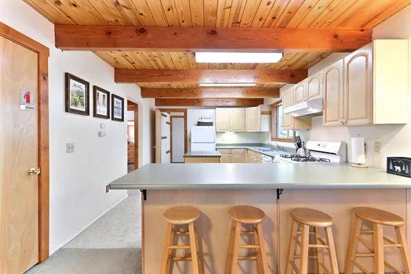 a kitchen with stainless steel appliances granite countertop a sink a stove and refrigerator