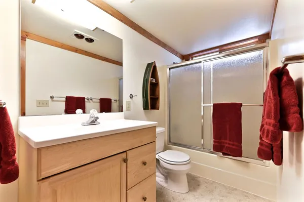 a bathroom with a sink toilet and shower