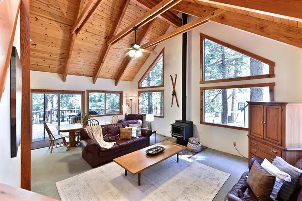 a living room with furniture and floor to ceiling windows
