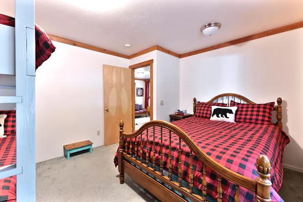 a backyard of a house with wooden fence and large trees