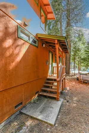 a view of a balcony with wooden floor and fence