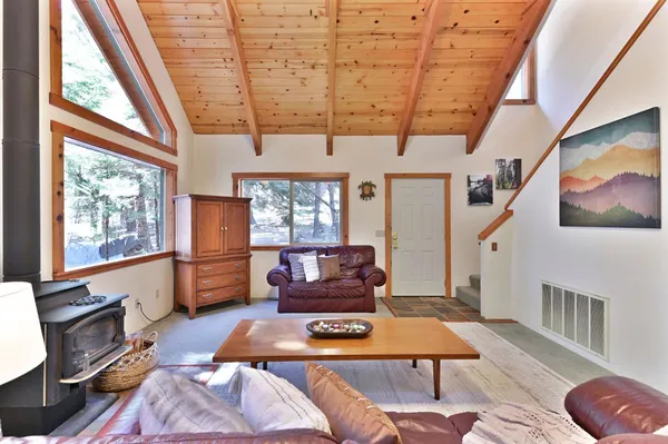 a living room with furniture a flat screen tv and a window
