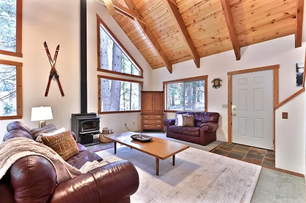 a living room with furniture a fireplace and a large window