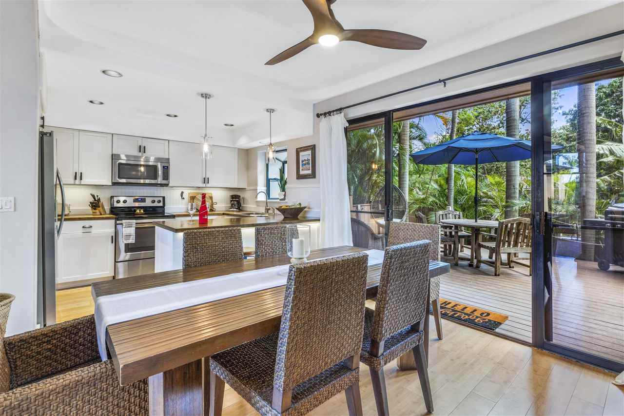 5432 Lower Honoapiilani Road, Unit B7 Lahaina, HI 96761 - Photo 1 of 27 a kitchen with stainless steel appliances granite countertop a stove a refrigerator a couch and a dining table with the view of living room