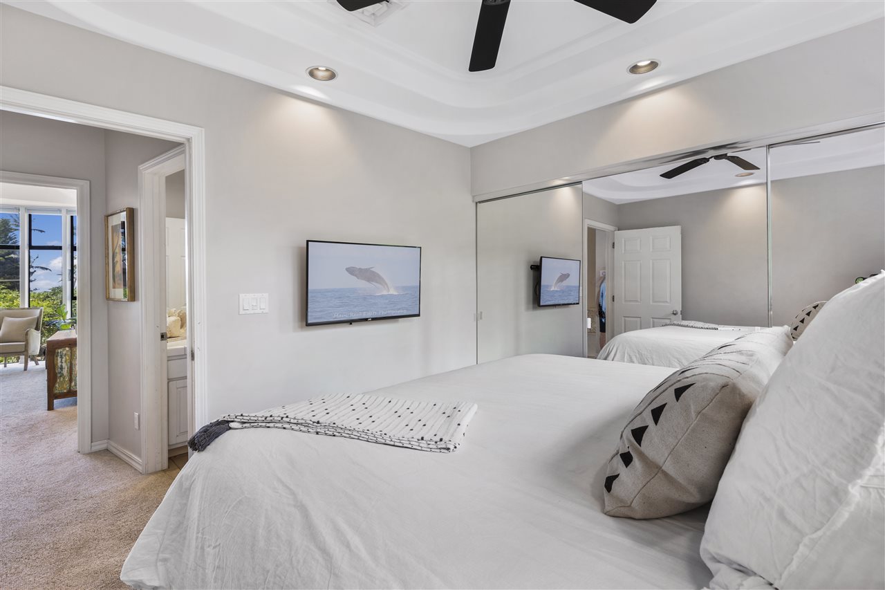 5432 Lower Honoapiilani Road, Unit B7 Lahaina, HI 96761 - Photo 14 of 27 a bedroom with a bed and a chandelier