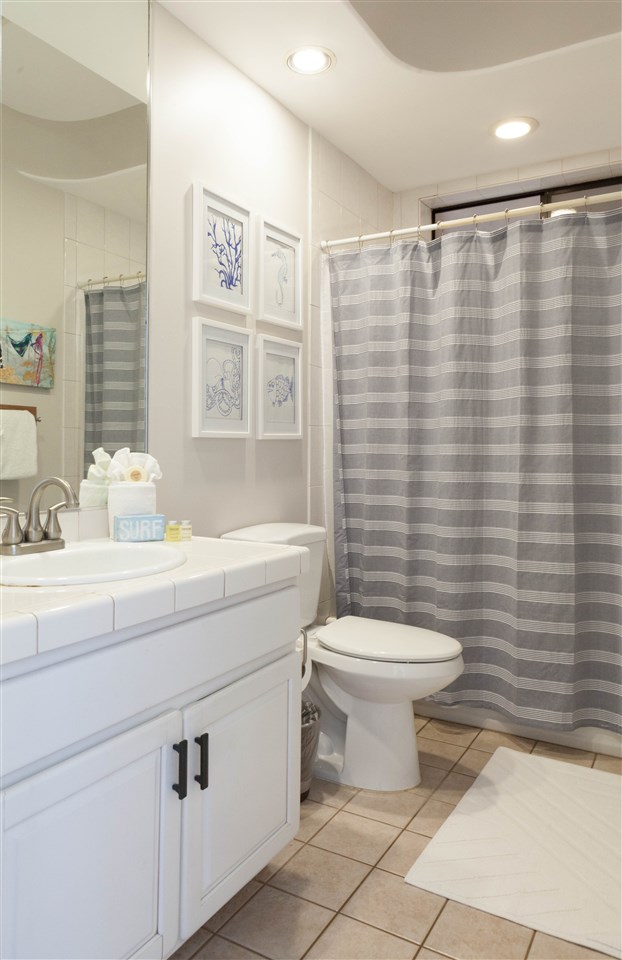 5432 Lower Honoapiilani Road, Unit B7 Lahaina, HI 96761 - Photo 16 of 27 a bathroom with a sink a toilet and shower curtain