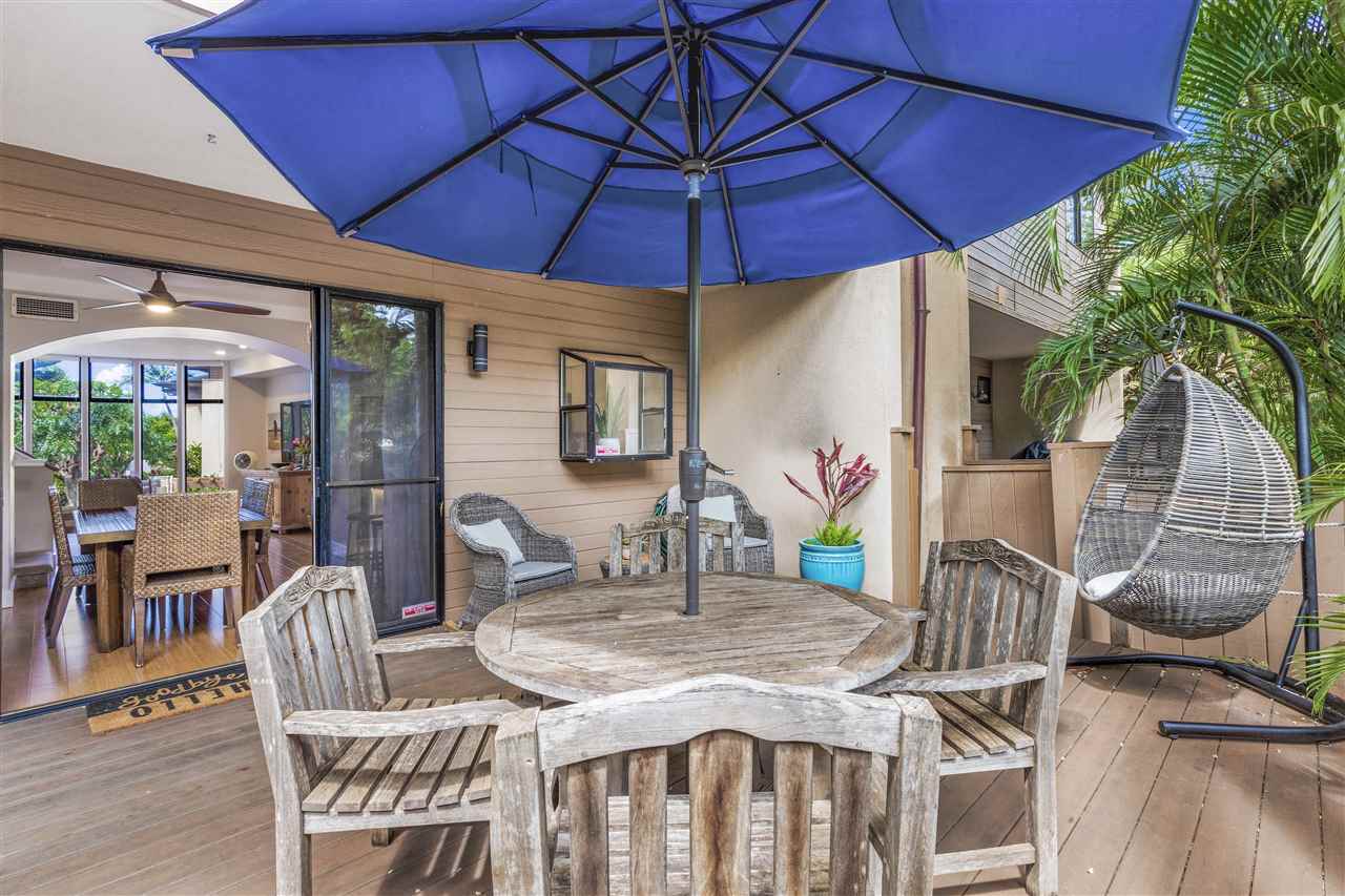 5432 Lower Honoapiilani Road, Unit B7 Lahaina, HI 96761 - Photo 19 of 27 a patio with a table and chairs under an umbrella