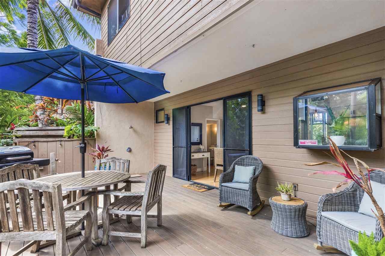 5432 Lower Honoapiilani Road, Unit B7 Lahaina, HI 96761 - Photo 21 of 27 a view of a patio with a table and chairs under an umbrella