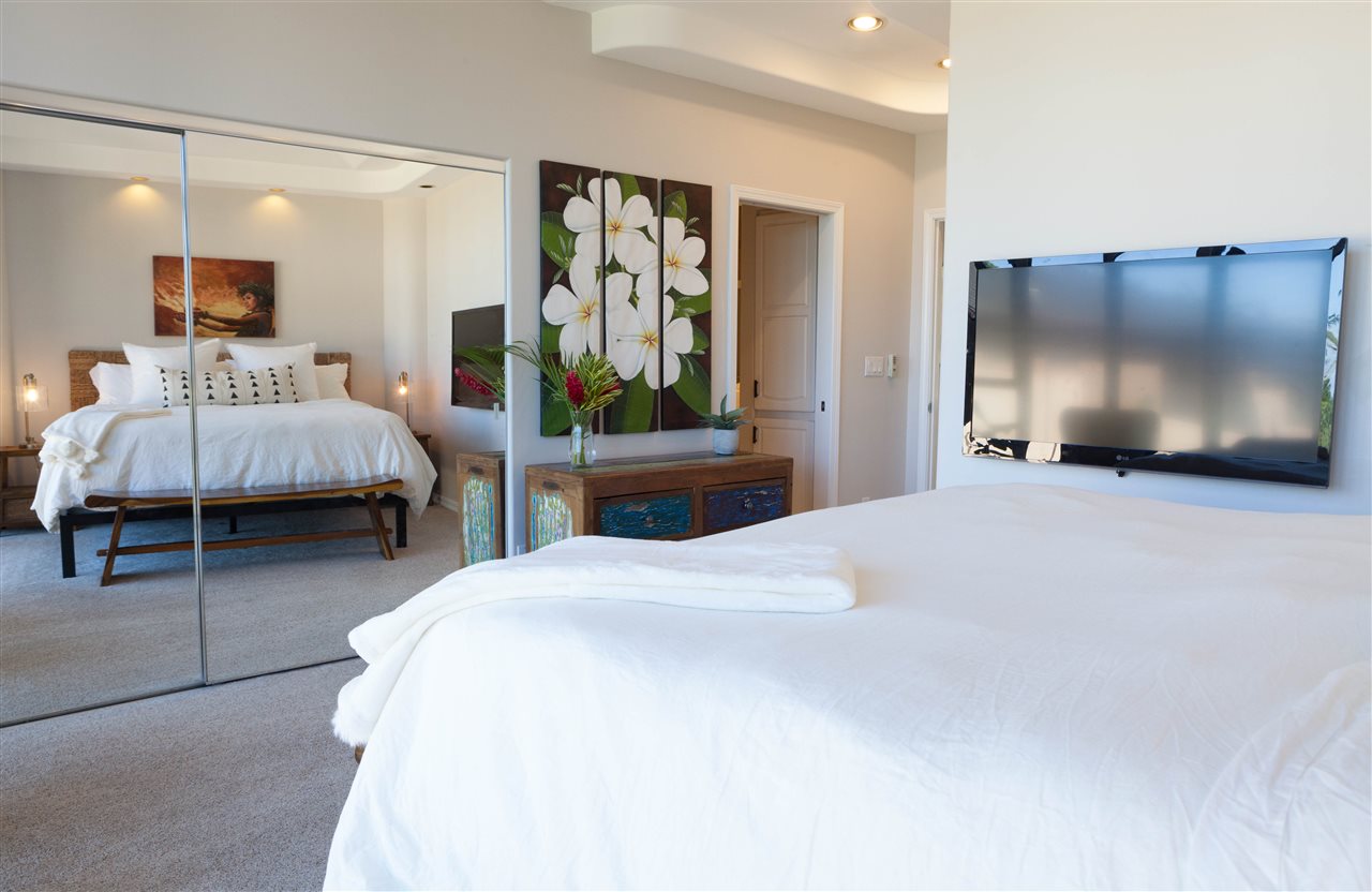 5432 Lower Honoapiilani Road, Unit B7 Lahaina, HI 96761 - Photo 10 of 27 a bedroom with a bed and large flat screen tv