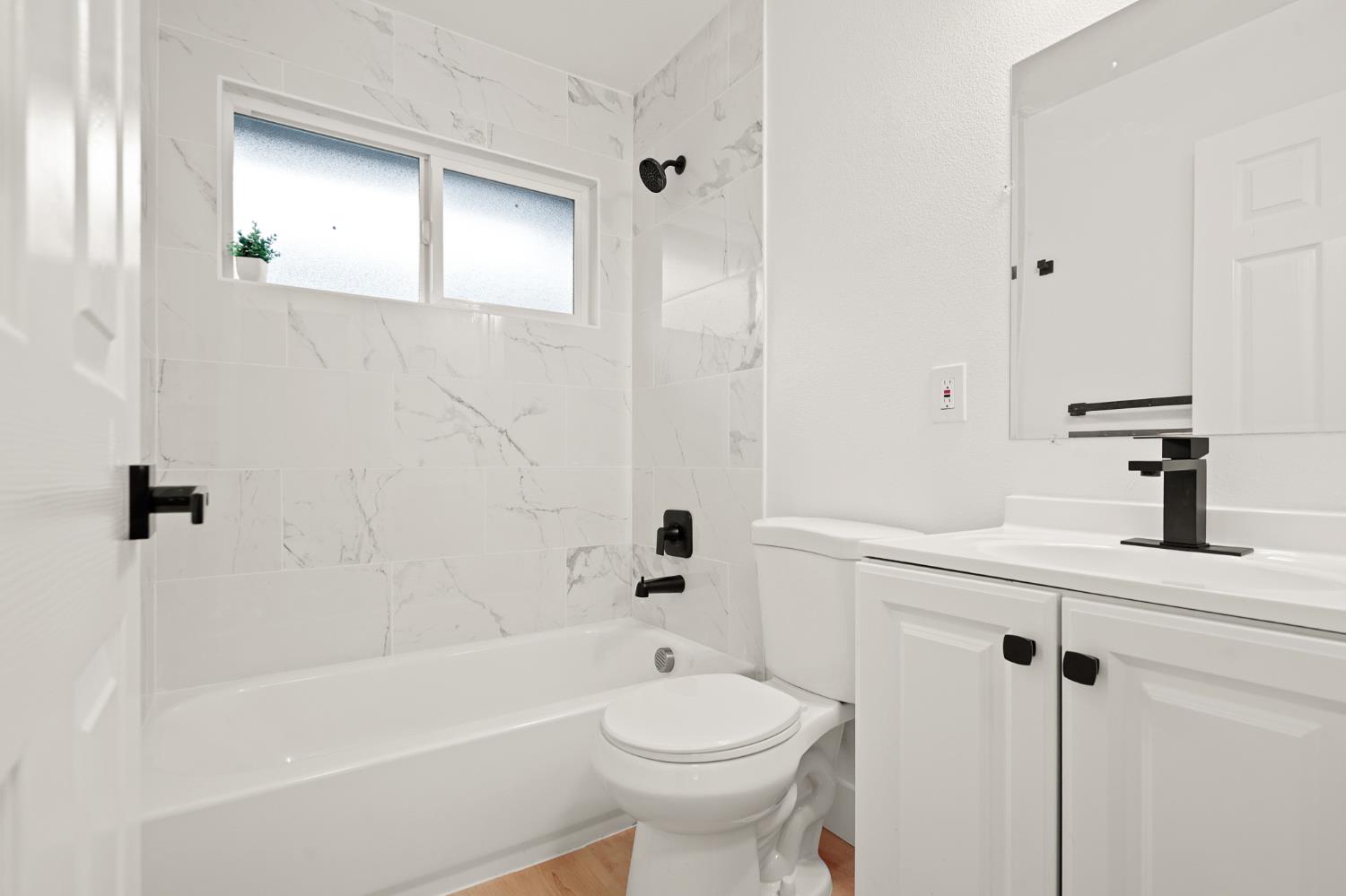 1719 West Swain Road, Unit A Stockton, CA 95207 - Photo 17 of 25 a bathroom with a sink a toilet and shower