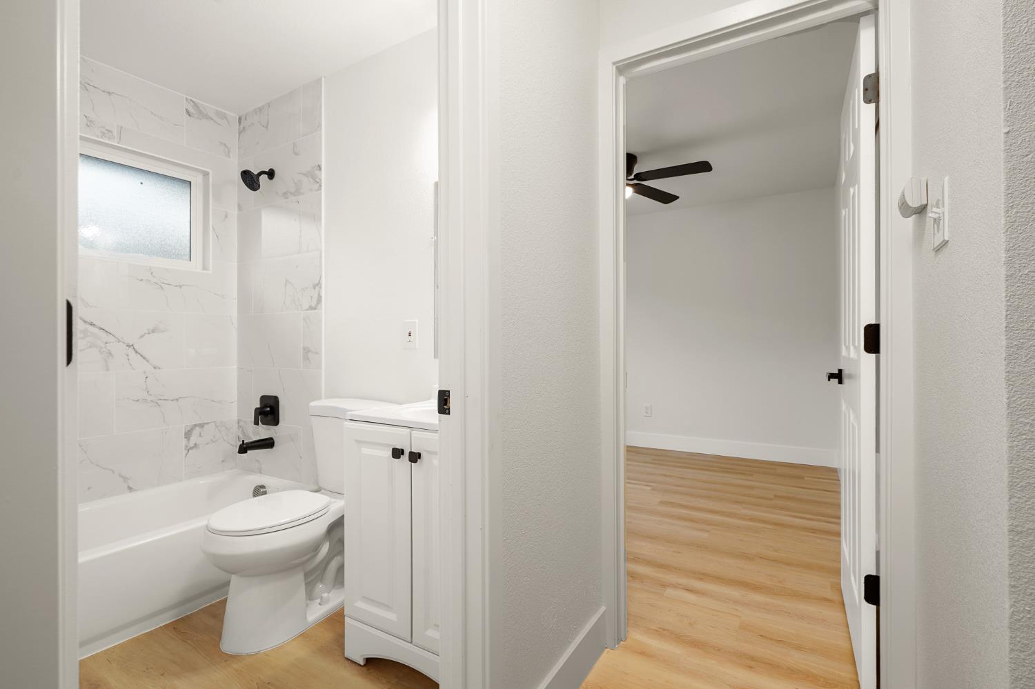 1719 West Swain Road, Unit A Stockton, CA 95207 - Photo 18 of 25 a bathroom with a toilet a sink and a shower