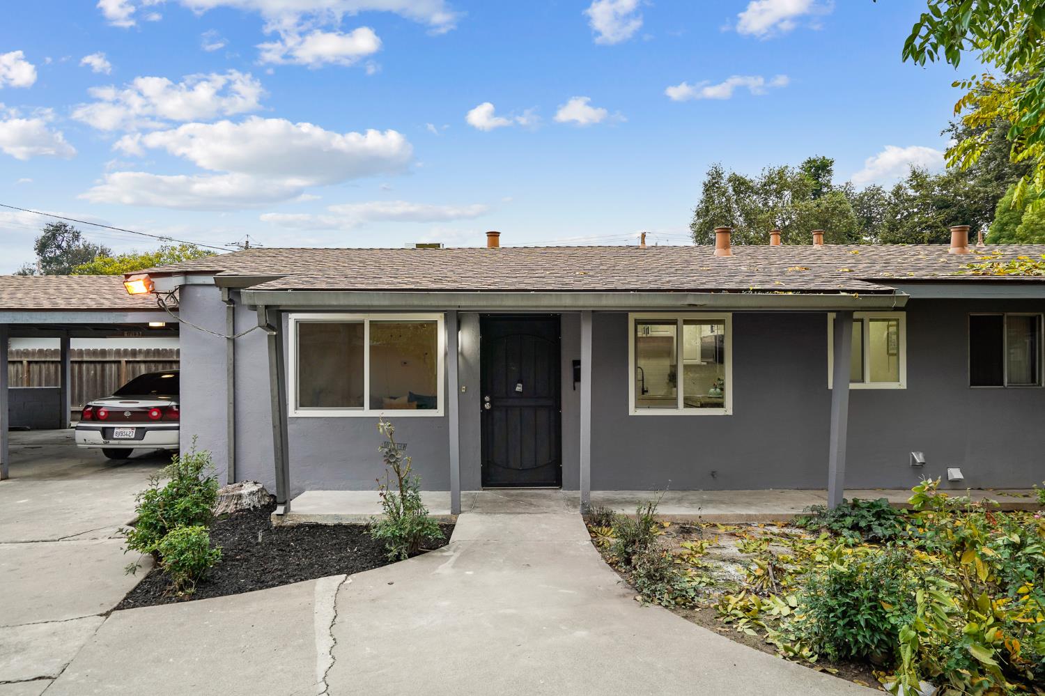 1719 West Swain Road, Unit A Stockton, CA 95207 - Photo 4 of 25 a front view of a house with a garden