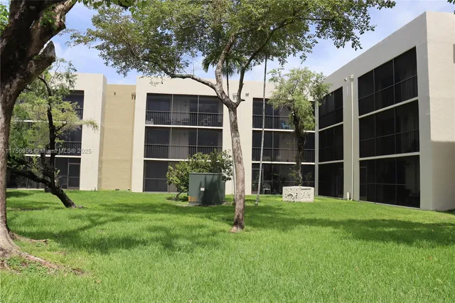a view of an house with backyard space and balcony
