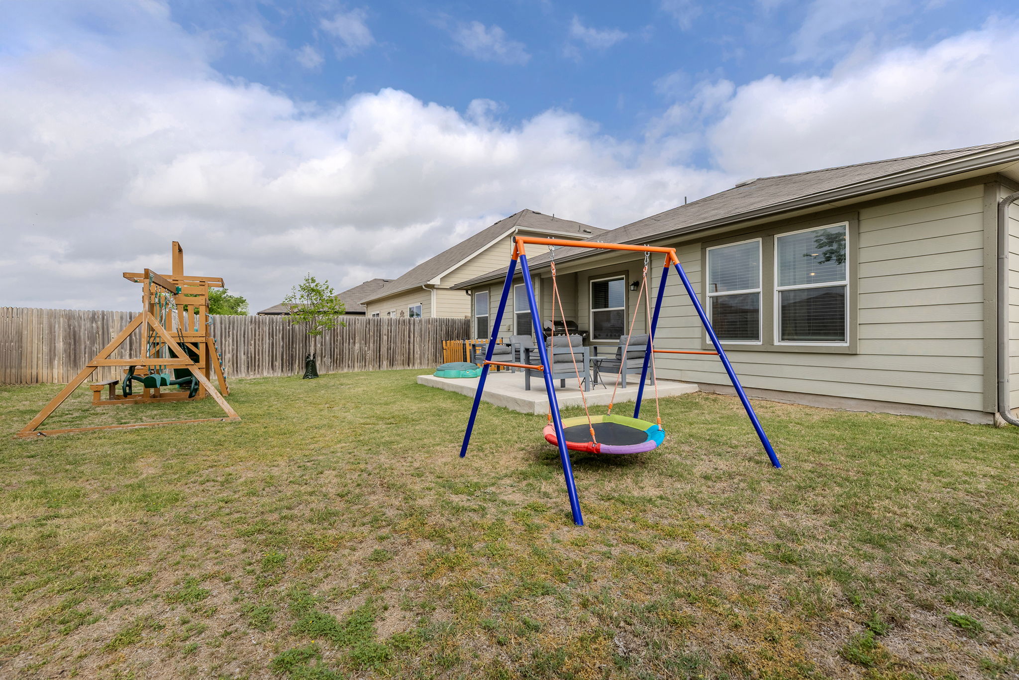 404 Cassandra Drive Hutto, TX 78634 - Photo 37 of 40 Fenced backyard featuring a playground and a patio area