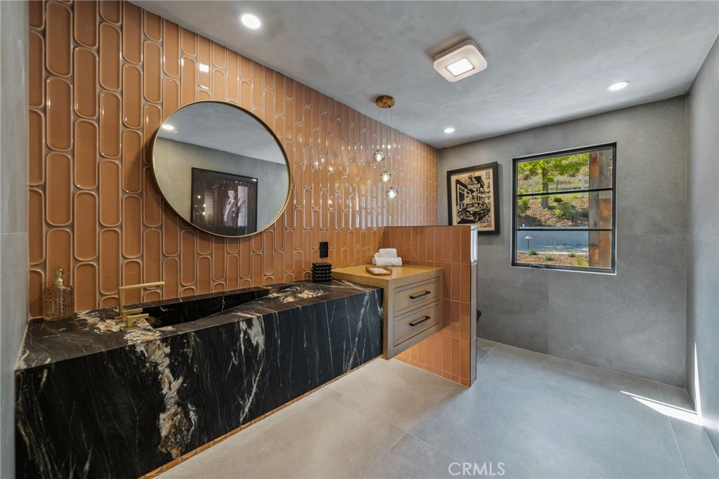 5510 Hoback Glen Road Hidden Hills, CA 91302 - Photo 21 of 60 a bathroom with a sink and a mirror