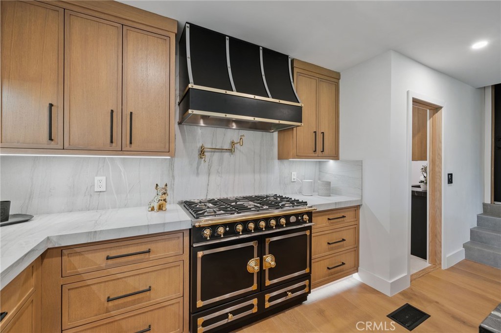 5510 Hoback Glen Road Hidden Hills, CA 91302 - Photo 25 of 60 a kitchen with stainless steel appliances granite countertop a stove and a white cabinets