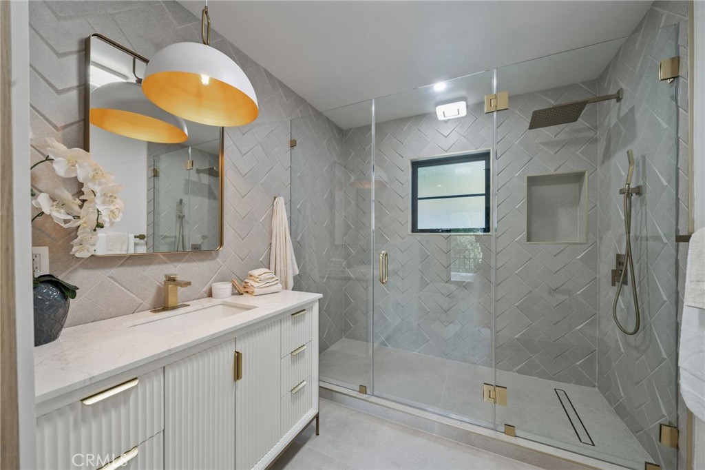5510 Hoback Glen Road Hidden Hills, CA 91302 - Photo 29 of 60 a bathroom with a sink a mirror a vanity and a shower