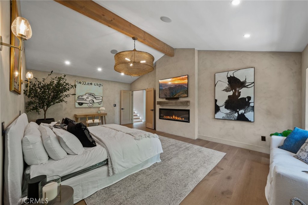 5510 Hoback Glen Road Hidden Hills, CA 91302 - Photo 33 of 60 a spacious bedroom with a bed and a television