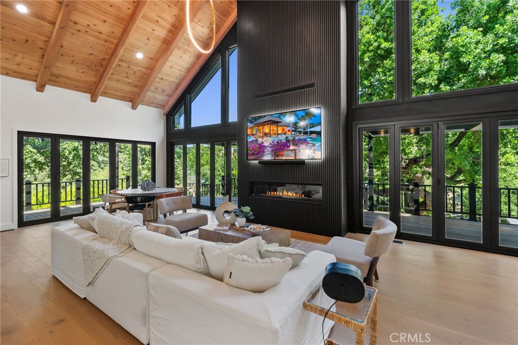5510 Hoback Glen Road Hidden Hills, CA 91302 - Photo 5 of 60 a living room with fireplace furniture and a flat screen tv