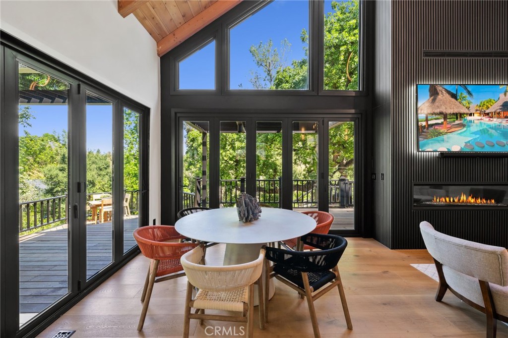 5510 Hoback Glen Road Hidden Hills, CA 91302 - Photo 9 of 60 a view of a dining room with furniture large windows and wooden floor