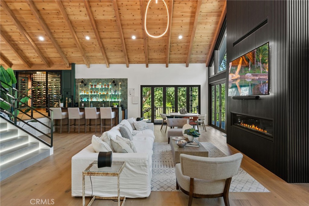 5510 Hoback Glen Road Hidden Hills, CA 91302 - Photo 10 of 60 a living room with furniture a floor to ceiling window and flat screen tv