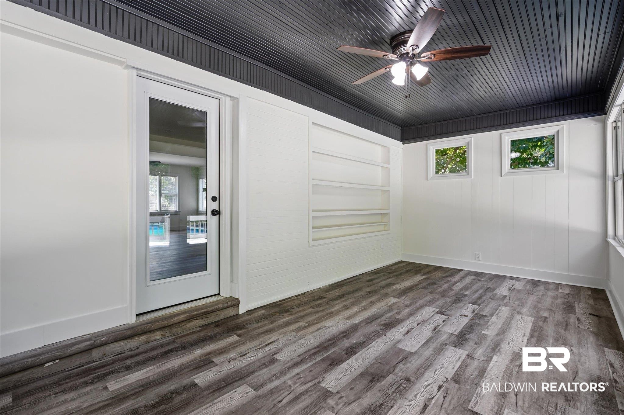 308 Byron Avenue West Mobile, AL 36609 - Photo 18 of 33 Spare room featuring a healthy amount of sunlight, hardwood / wood-style floors, and ceiling fan