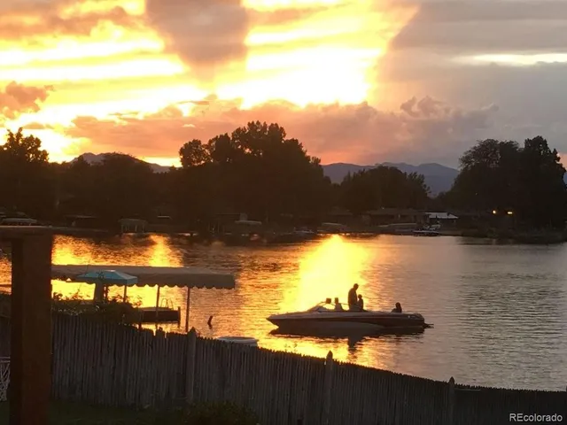 a group of people sitting on top of a lake