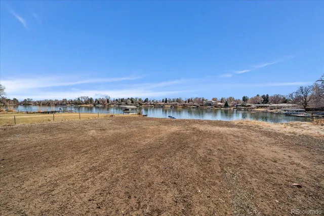 a view of a lake with houses in the back