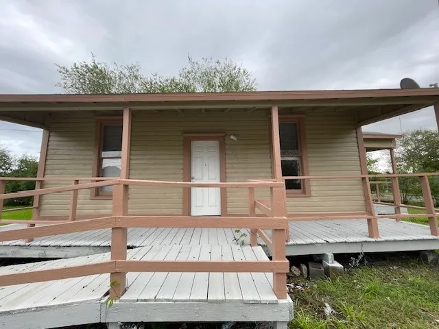a view of a small house with roof deck