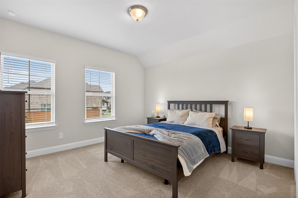 1002 Coppersmith Way Forney, TX 75126 - Photo 20 of 39 a bedroom with a bed and a window