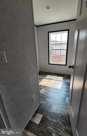 a view of a town with barn house in the background