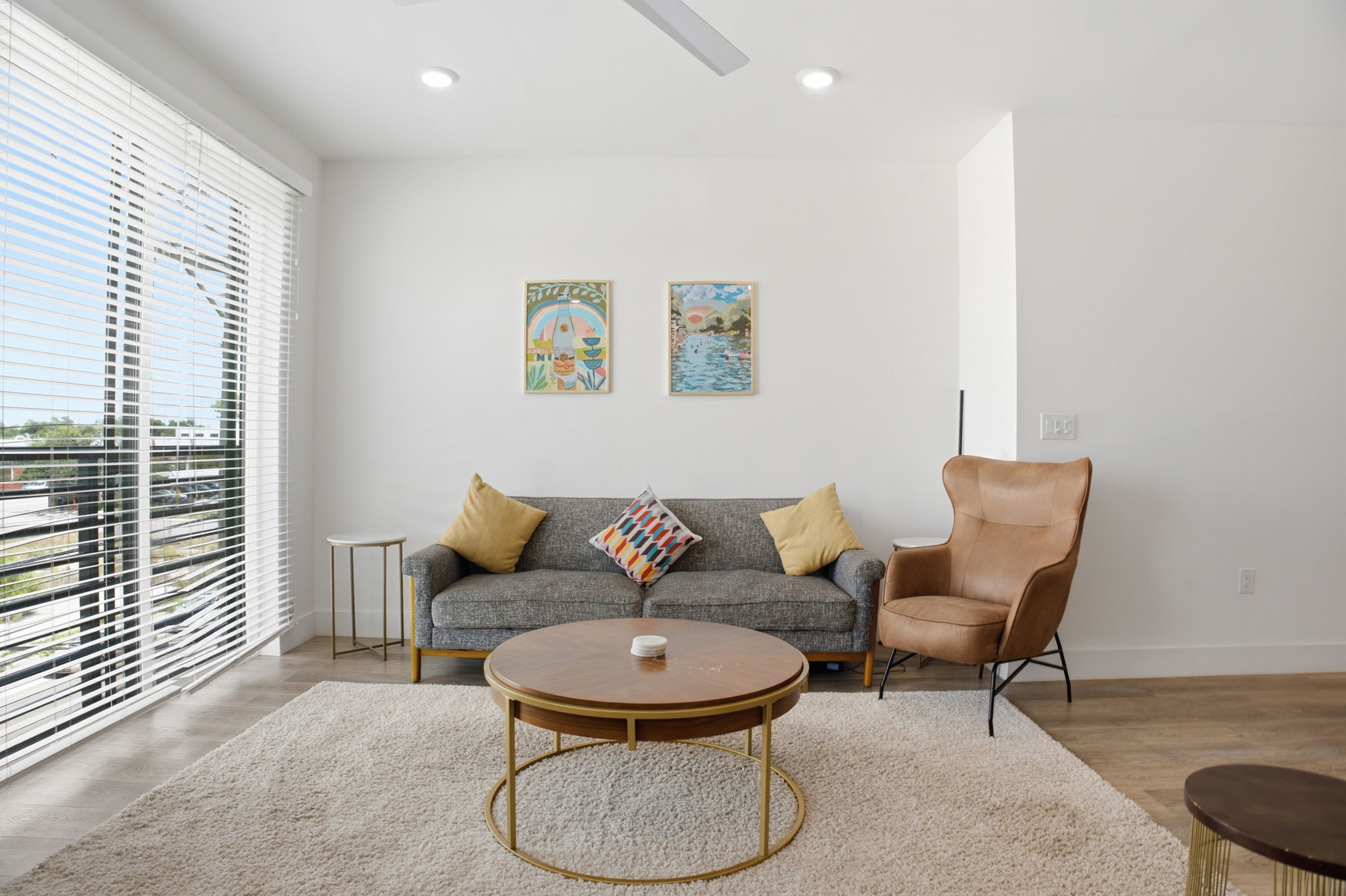 2709 East 5th Street, Unit 1306 Austin, TX 78702 - Photo 6 of 28 Comfortable open living area with large windows, recessed lighting, and durable hardwood flooring.