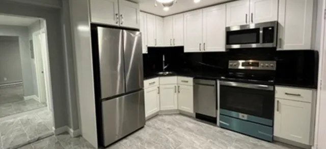 a kitchen with a refrigerator stove and microwave