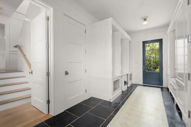a bedroom with a bed and a view of living room